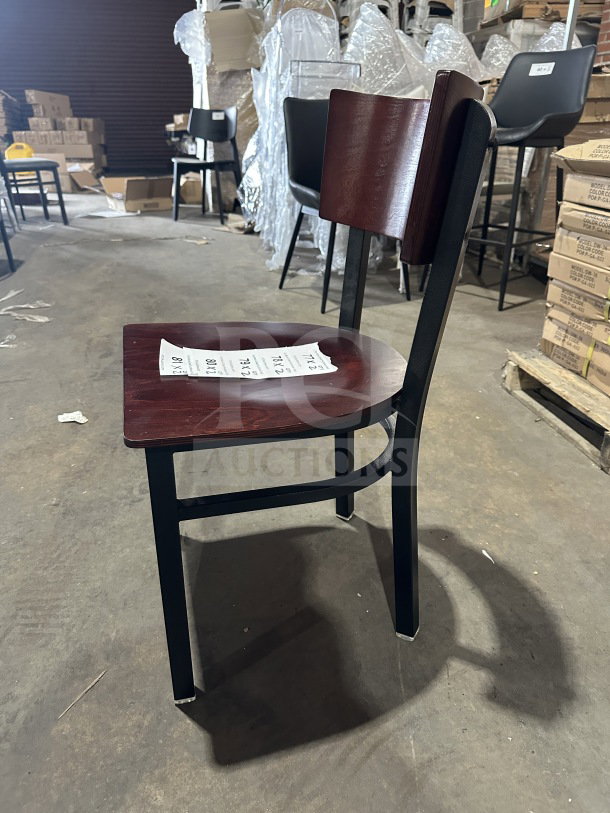 Brand new commercial restaurant chair with mahogany wood back and veneer seat, metal frame. Tags visible on seat.