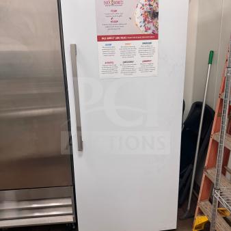 Commercial refrigerator with adjustable shelving. Good condition, minor cosmetic wear. Sign on door details "Duck Donuts."