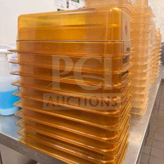 Stack of durable, high-quality food storage pans in amber color on a metal shelf. Essential kitchenware.