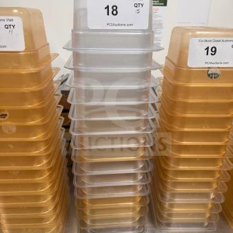 Stacks of durable, high-quality food storage pans. Includes clear and amber pans. Auction labels show quantities.