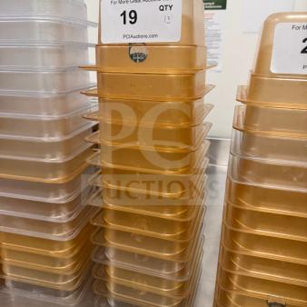Stack of durable food storage pans with labels indicating quantity for auction. High-quality, transparent design.