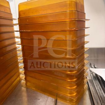 Stack of amber food storage pans; durable, high-quality material; good condition; ideal for kitchen use.