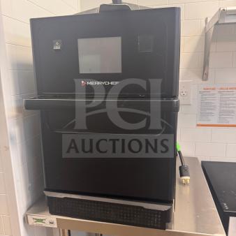 Merrychef e1S high-speed oven, model e1SGHMV6XHU2US, pre-owned, fully operational, minor wear, on a metal stand.