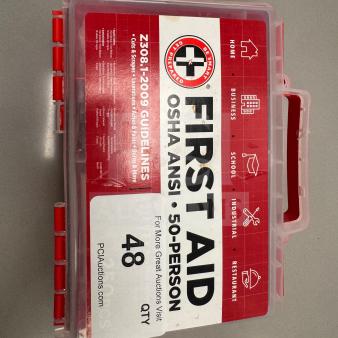 First Aid Kit, OSHA ANSI for 50 persons, excellent condition. Features red and clear plastic case, compliance label visible.