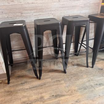 Set of 4 black metal stools in excellent condition with minimal wear, featuring a sleek design and sturdy construction.