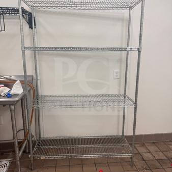 Heavy-duty wire shelving unit, commercial storage rack, pre-owned in good condition. Clean, four-tier structure, minimal wear.