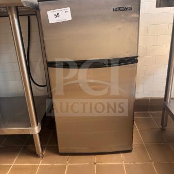 Thomson stainless steel mini fridge, pre-owned with minor cosmetic wear, fully functional, auction tag "55" visible.