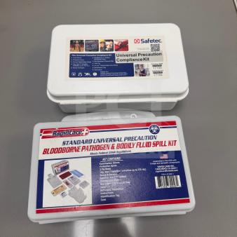 Set of 2 Universal Precaution Compliance Kits by Safetec and Rapid Care. Includes gloves, masks, and spill supplies.