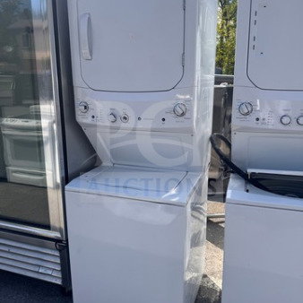 GE 24" Spacemaker stacked washer and dryer combo, white, used, good condition, minor cosmetic wear, control dials visible.