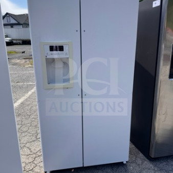 White GE side-by-side refrigerator with water and ice dispenser. Used condition, missing handle, minor cosmetic wear. Tested and working.