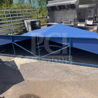 Large blue metal industrial structure with triangular roof, visible framework; outdoor setting, appears used. Condition details unspecified.