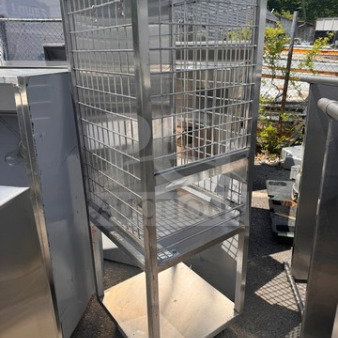 Stainless steel storage cart with wire shelves, minor scuffs, no rust or significant damage, in good condition.