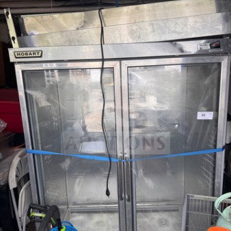 Hobart DA2-5 commercial refrigerator, two glass doors, used condition with visible scratches, no interior racks.