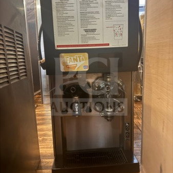 Used FBD 372-611-1012 slushy machine with visible wear. Features dual hoppers and instructions on front panel. Working condition.