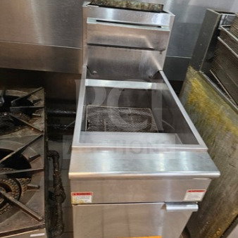 Commercial floor model gas fryer, 50 lb oil capacity, operates on natural gas. Very nice condition with visible warning labels.