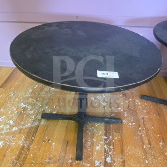 Lot of 4 round tables on sale; 3 are 36" and 1 is 29.5". Feature black surfaces and sturdy black bases.