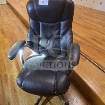 Black leather office chair with cushioned armrests and five-wheel base. Visible wear on seat and backrest. Auction tag "116".