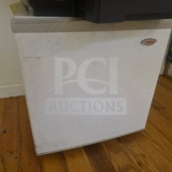 White Haier mini fridge with visible scuffs, unknown working condition, sold as is.