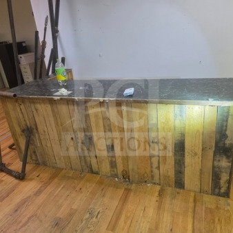 Wooden pallet bar with a marble-like top, rustic design, metal pipe accents, used condition, suitable for home bar setup.
