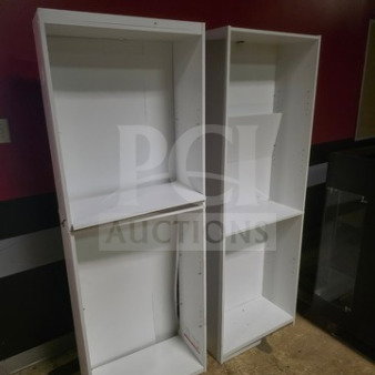 Lot of two white shelves, varying sizes, visible wear. Sold as is. Ideal for storage or display.