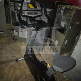 Cybex 530C commercial upright exercise bike; unknown working condition; gray frame with digital display and adjustable seat.