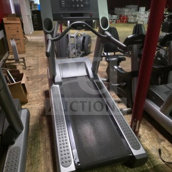 Life Fitness 95Ti commercial treadmill, unknown working condition, sold as is. Features control panel and sturdy frame.