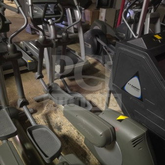 Life Fitness commercial-grade elliptical trainer, unknown working condition, sold as-is. Features dual handlebars, digital display.