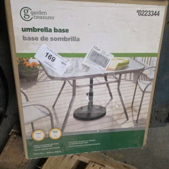 Garden Treasures umbrella base in box. Model #0223344. Features sturdy design for patio umbrellas. New condition.