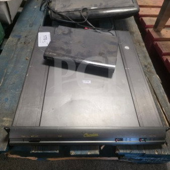 Lot of miscellaneous electronics including two laptops and a countertop warmer. Items show signs of wear and use.