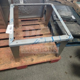 Stainless Steel Ice Bin Leg Stand, new condition, featuring sturdy legs and protective wrapping, on wooden pallet.