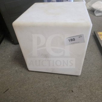 White cube side table with some surface wear. Auction label marked "180 QTY." Simple, modern design.