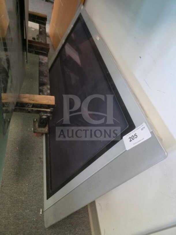 Philips flat screen TV, unknown working condition, silver frame, sold as is, auction tag "205" visible.