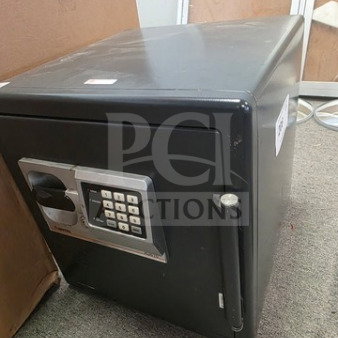 Black safe box with electronic keypad, no known combination. Rectangular shape, minor wear, sturdy handle, and side locking bolt.