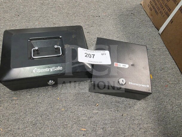 Lot of two cash boxes, SentrySafe and Honeywell, no keys, black finish, visible auction tag 207, good condition.