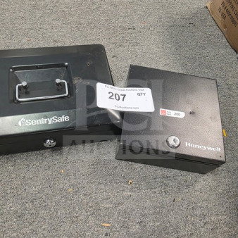 Lot of two cash boxes, SentrySafe and Honeywell, no keys, black finish, visible auction tag 207, good condition.