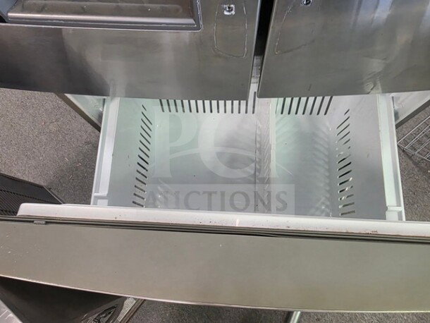 Stainless steel LG French door refrigerator with open drawer, unknown condition, sold as is.