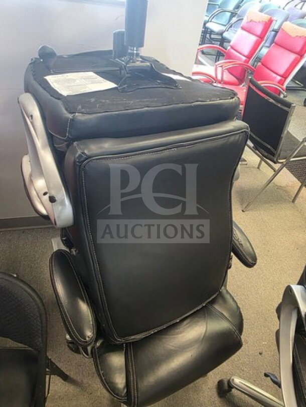 Lot of 4 black office chairs, leather upholstery, adjustable armrests. Some wear visible on the backrest and base.