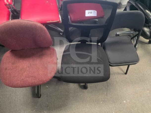 Lot of 3 mismatched office chairs, varying conditions. Includes red fabric, black mesh, and padded armchair. Visible wear on fabrics.
