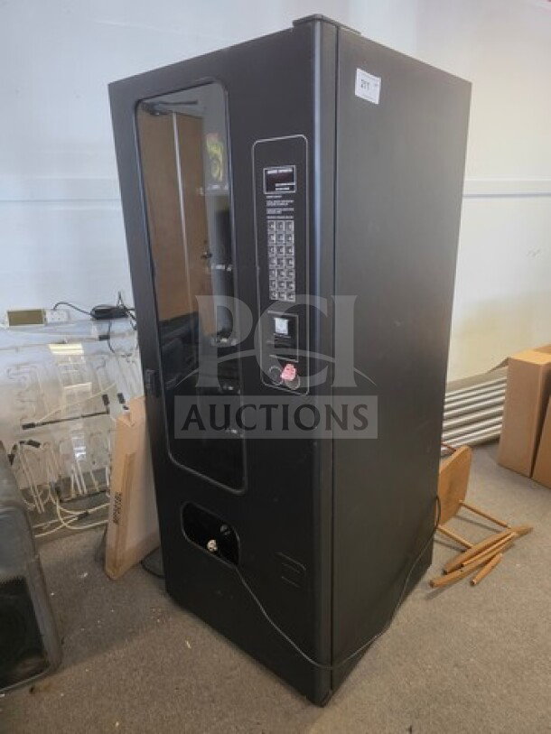 Black vending machine, unknown working condition, with coin slot and keypad. Sold as is.
