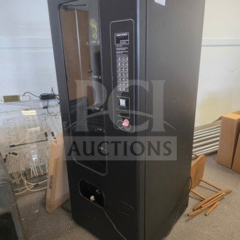 Black vending machine, unknown working condition, with coin slot and keypad. Sold as is.
