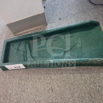 Green gutter splash block, rectangular, with signs of wear. Label marked "214" visible on side. Suitable for water drainage.
