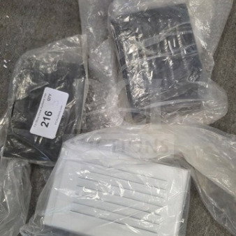 Lot of new faceplate covers in plastic wrap, includes black and white varieties. Visible label with number 216.