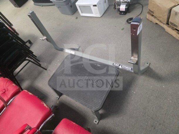 Deadlift platform by Flax Fitness, sturdy frame, rubberized base, slight wear. Branding visible on structural bar.