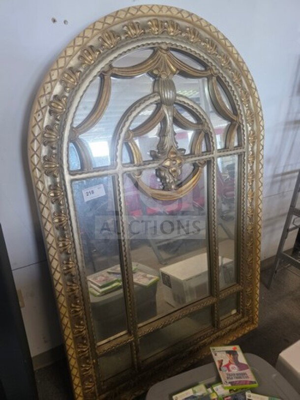 Elegant Palladian-style wall mirror with ornate gilded frame, arched top, and intricate design. Minor wear; ideal for decor.