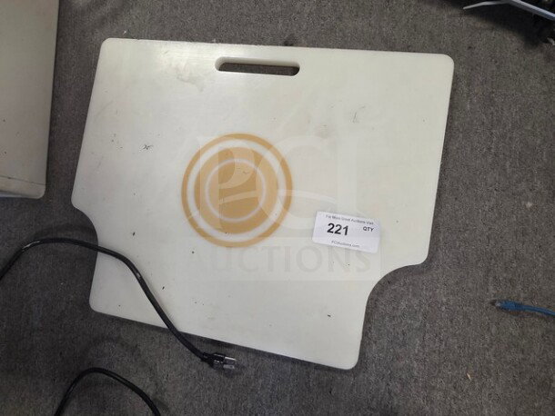 White cutting board with integrated handle, light wear, circular groove design, visible auction label "221 QTY."