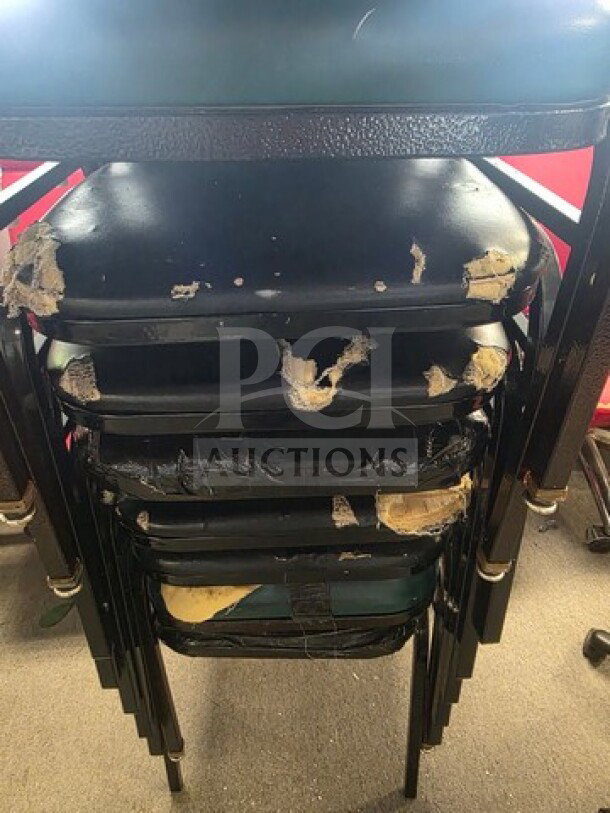 Lot of 9 stackable chairs showing significant wear and tear, with visible damage on black seats and frames.
