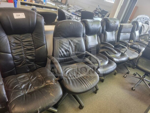 Lot of 12 black office chairs showing signs of wear; various styles and conditions, visible scuffs and tears on leather.