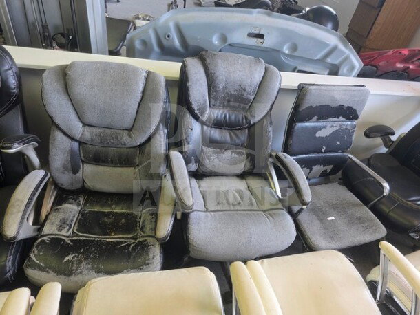 Lot of 12 assorted office chairs, various styles and colors, all showing signs of wear and tear, some visible damage.