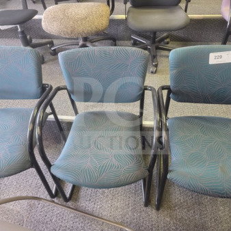 Lot of 3 office chairs with teal patterned fabric and black metal arms, in used condition, tag labeled "229".