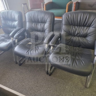 Lot of 3 black office chairs with chrome frames. Cushioned seats show signs of wear. One chair has a visible tear.